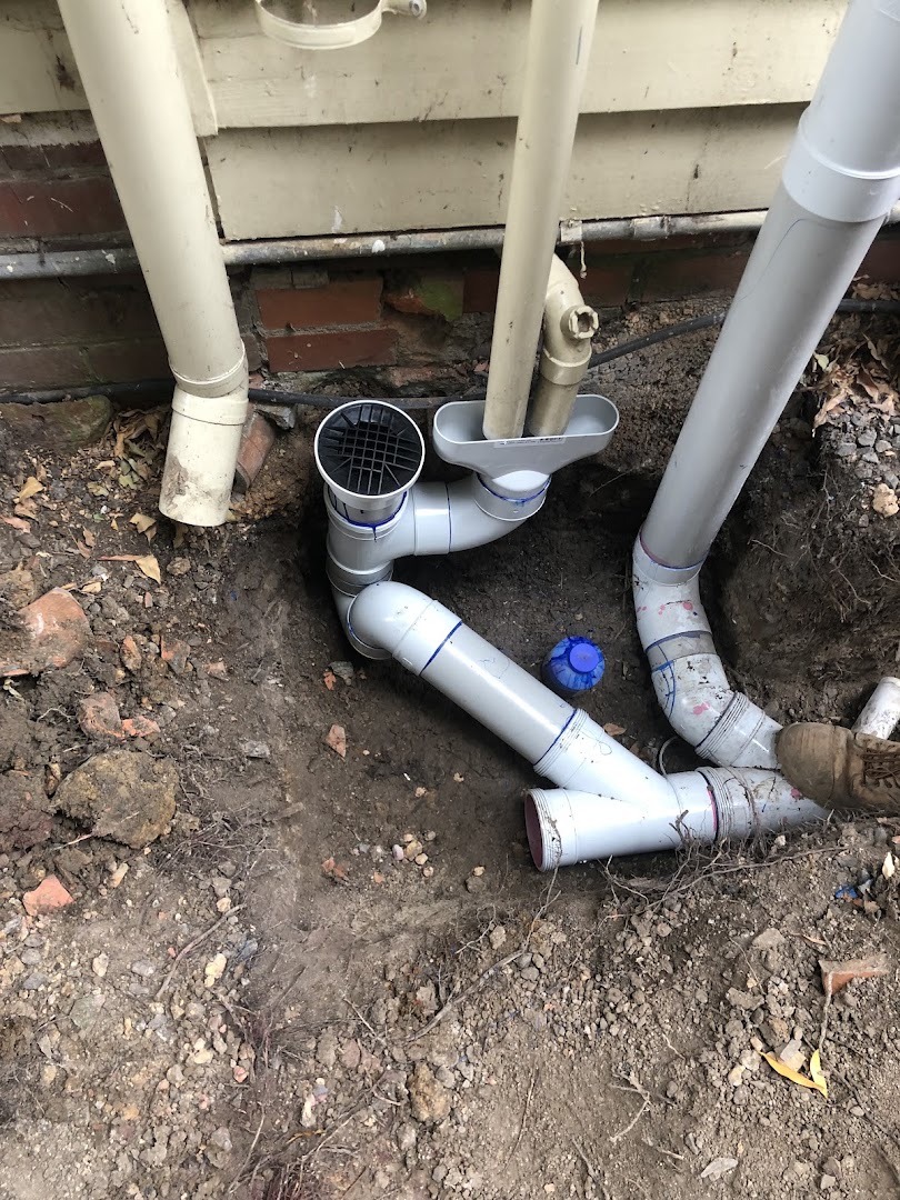 New PVC stormwater junctions fitted at the base of downpipes beside a Ballarat house