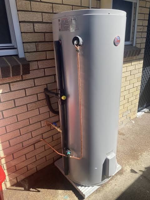 A hot water unit installed against the brick wall of a Ballarat home