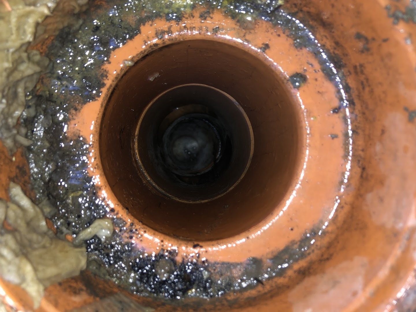 Looking down into an old earthenware drain opened up on a Ballarat job